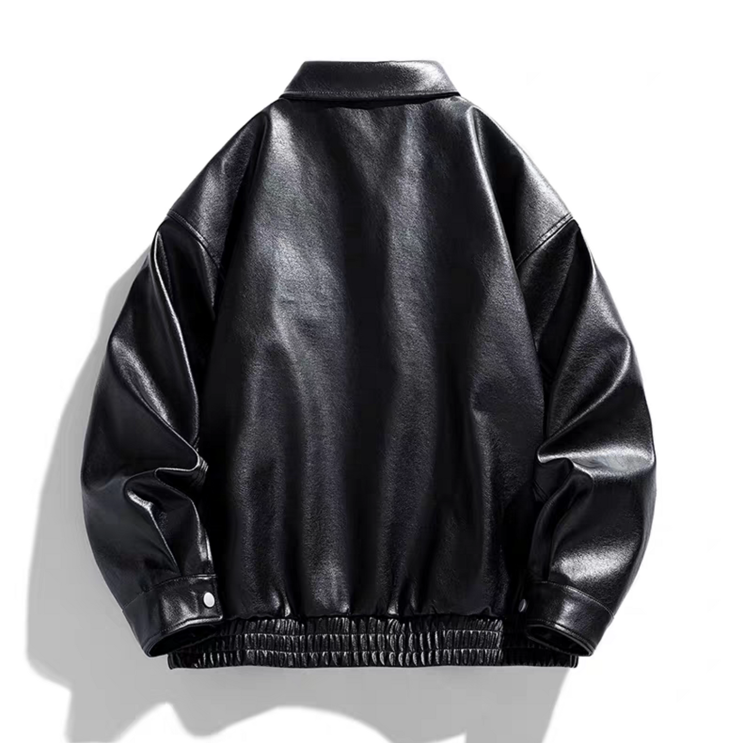 Back view of the STVLE black varsity jacket made from glossy PU leather, showcasing structured drop shoulders, elastic cuffs, and hem design