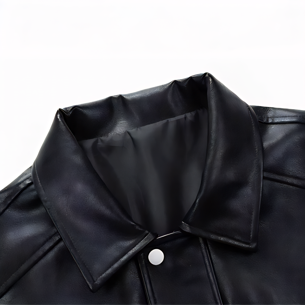 Black PU leather jacket collar detail with smooth inner lining and snap button closure, close-up on faux leather texture.