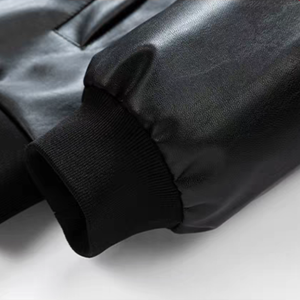 Close-up detail of black PU leather racing jacket cuff with ribbed knit finish