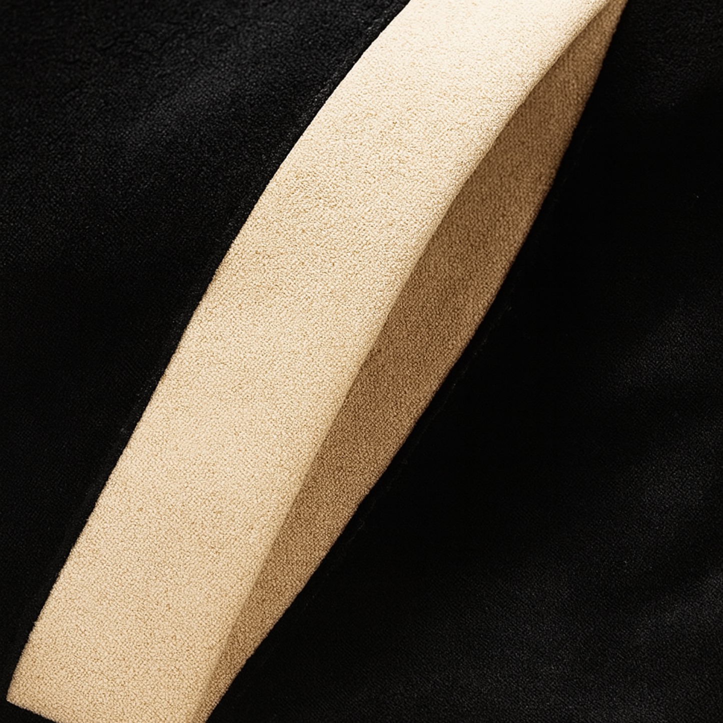 Close-up of beige side pocket on black Hantaliv varsity jacket with suede texture