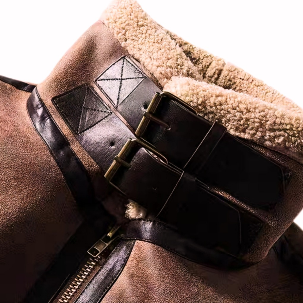 Close-up of brown faux shearling aviator jacket stand collar with dual leather buckle straps and plush shearling lining