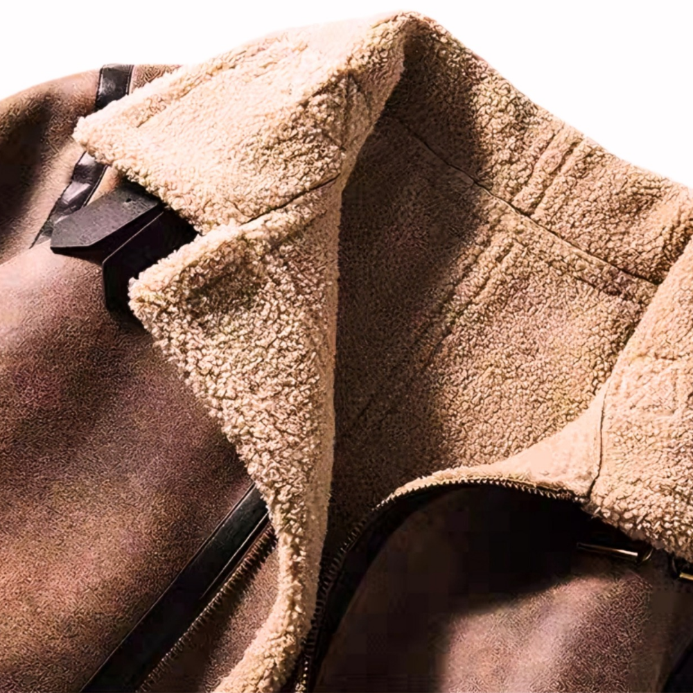 Close-up of brown faux shearling aviator jacket collar with buckle strap and plush vegan shearling lining