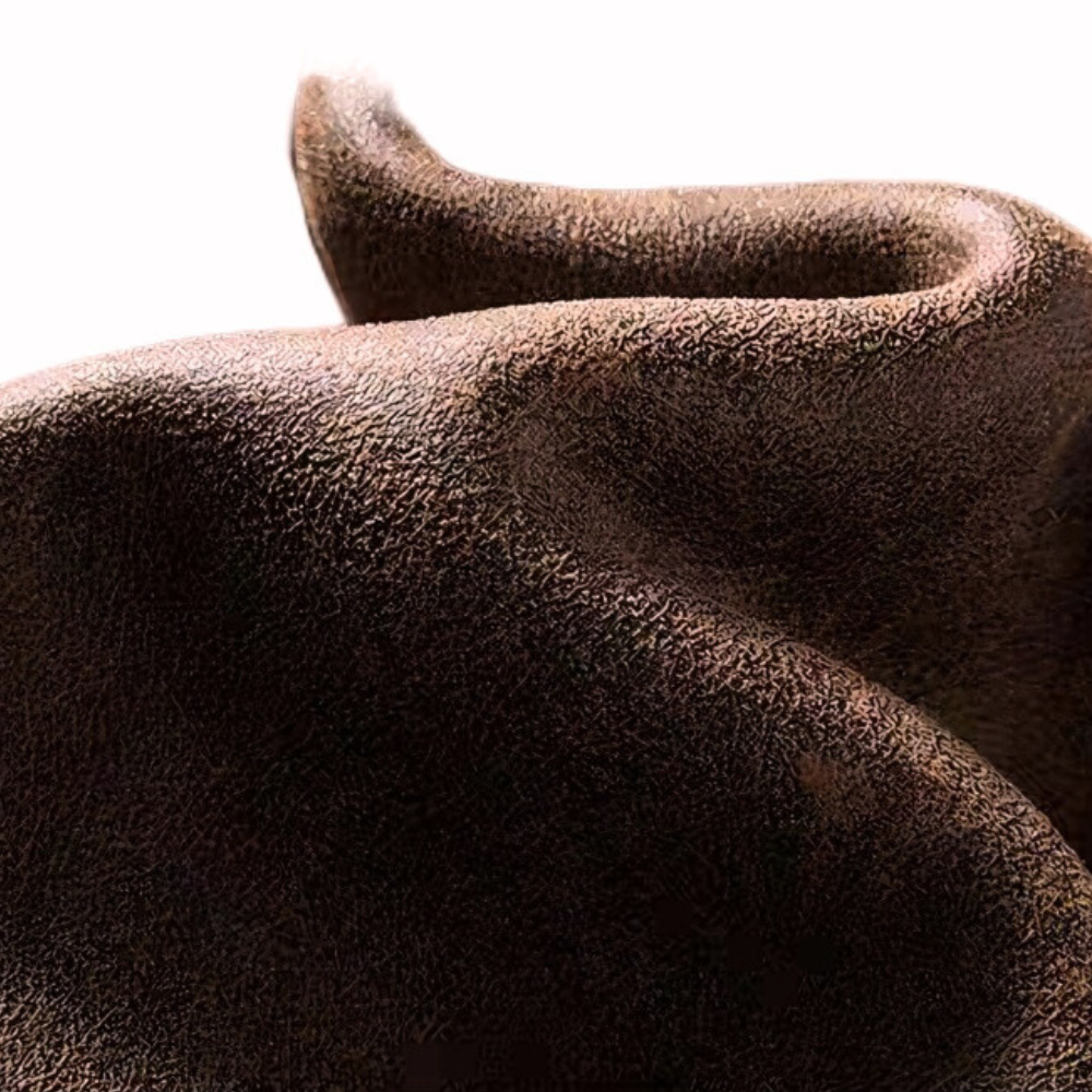 Close-up of brown faux suede fabric texture from aviator jacket, showing vintage distressed finish