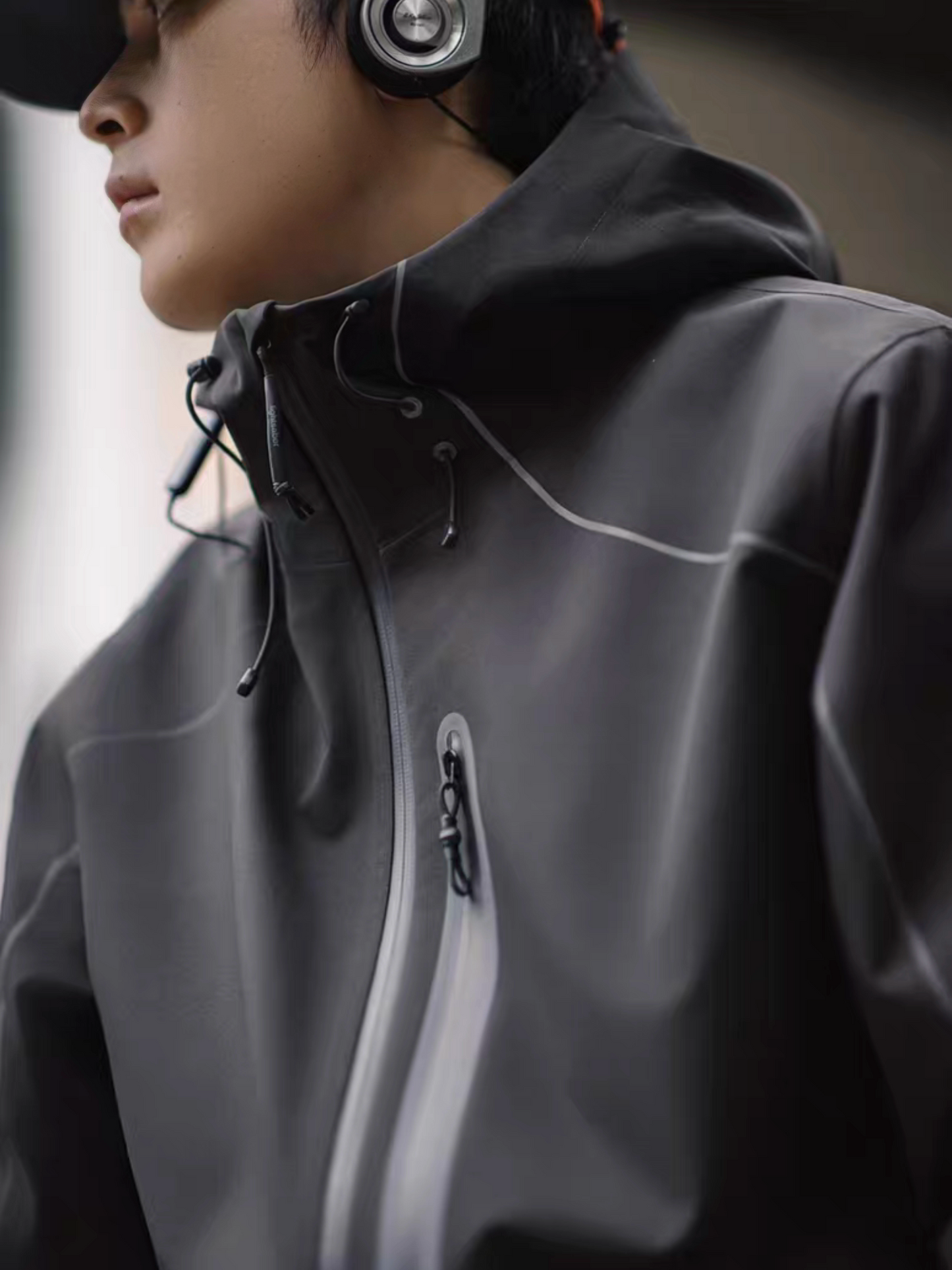 Side view of model wearing STVLE lightsaber reflective tech jacket, showing zipper and hood details