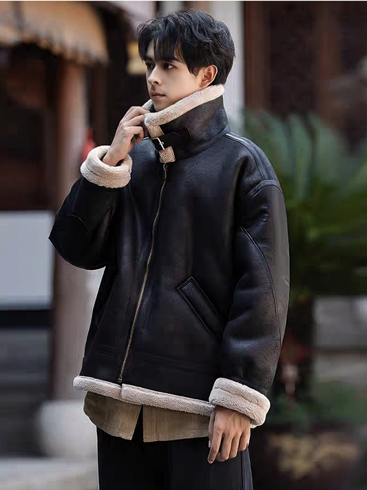 Man in black faux shearling aviator jacket with turned-up collar, outdoor winter street style