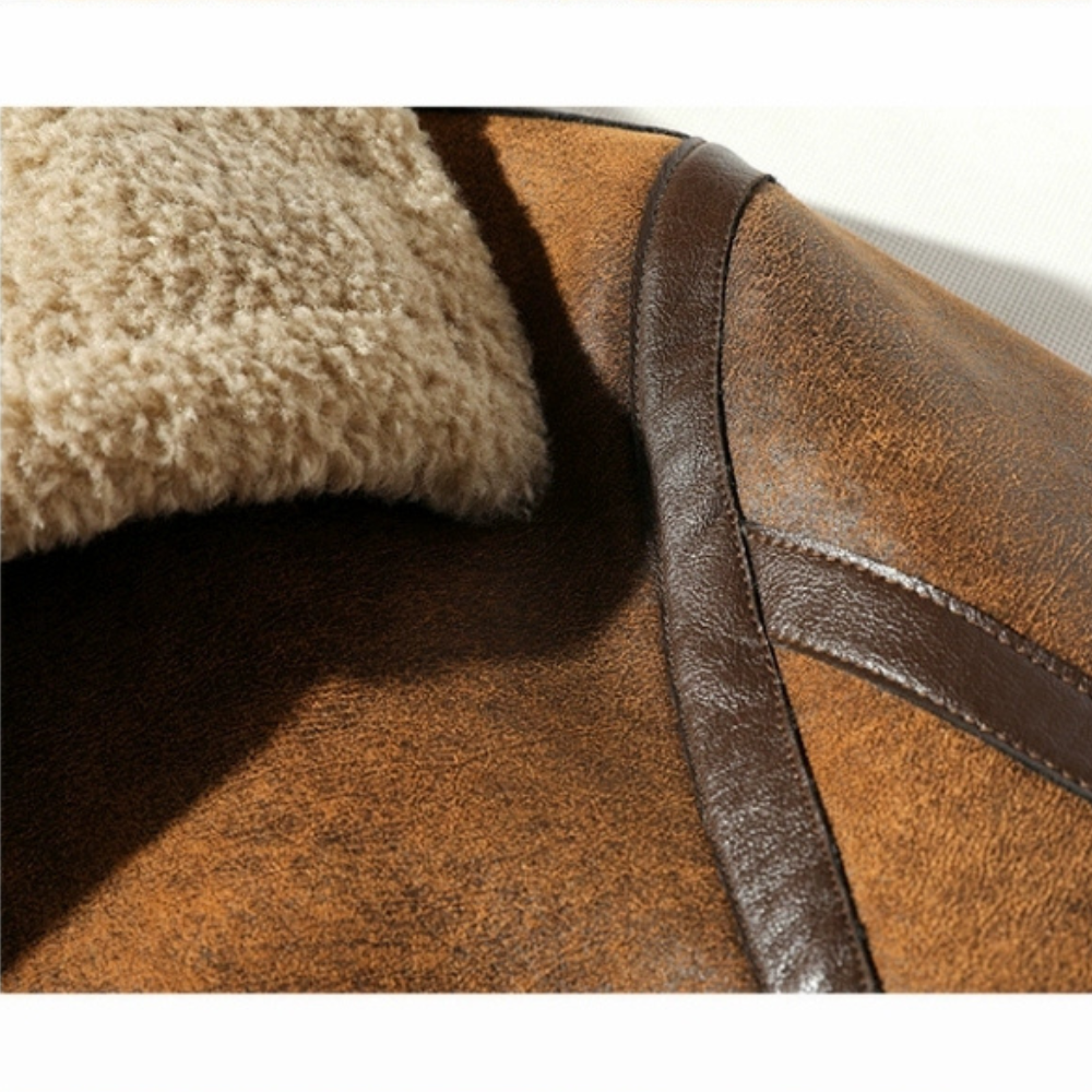Detail of brown faux suede aviator jacket shoulder with leather piping and soft shearling lining