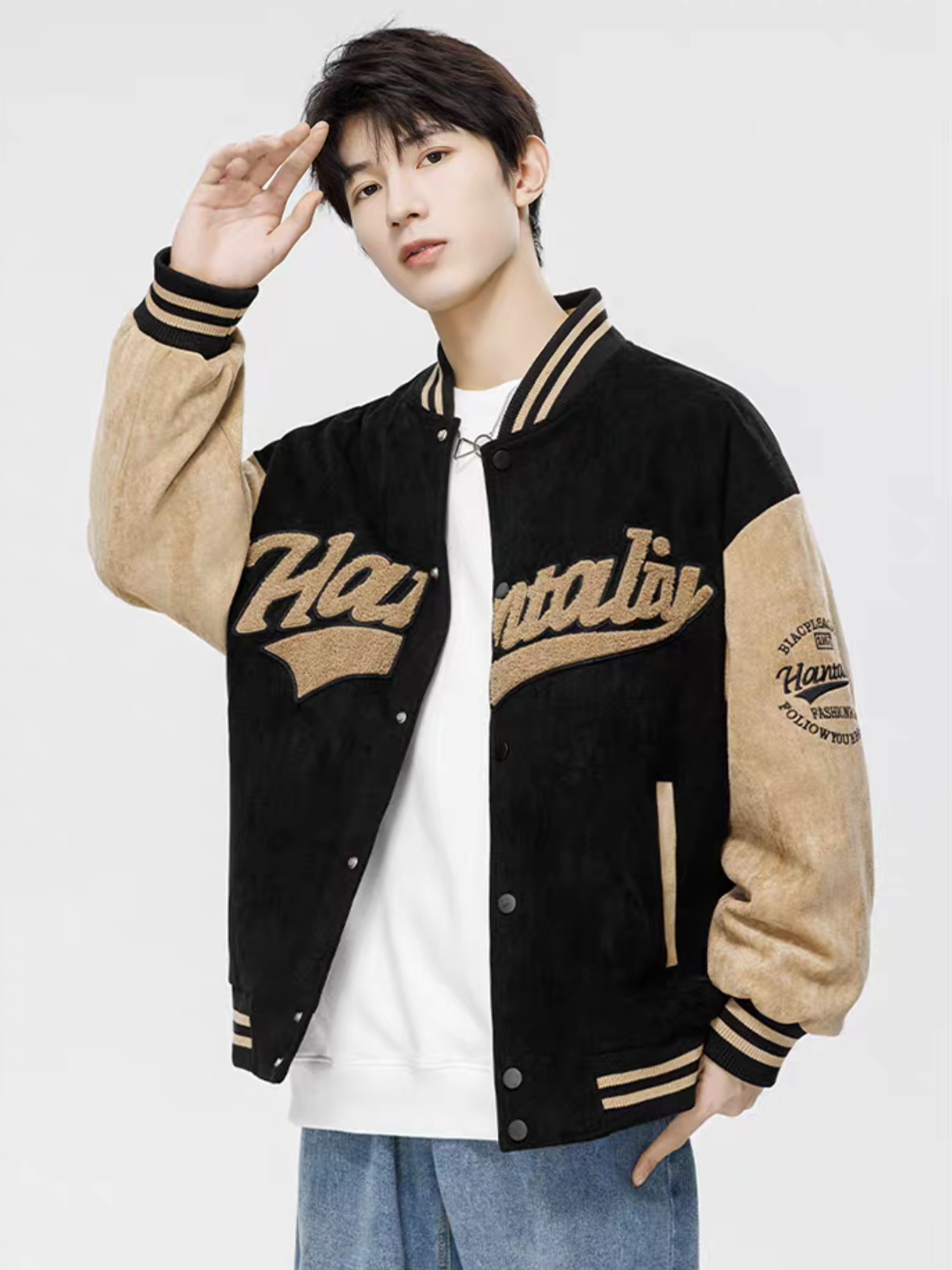 Model wearing black retro varsity jacket in suede